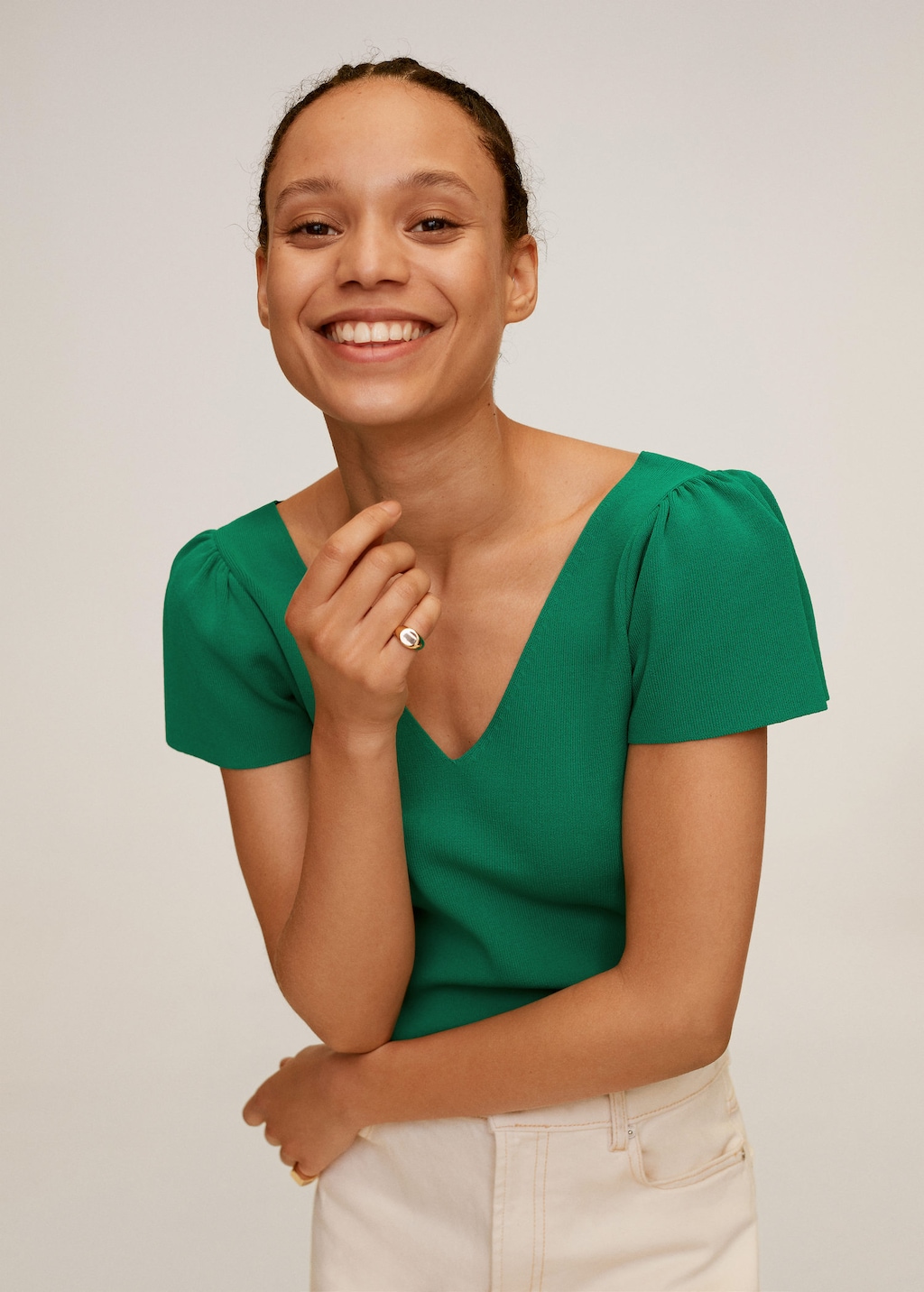 Woman smiling, wearing bright green blouse